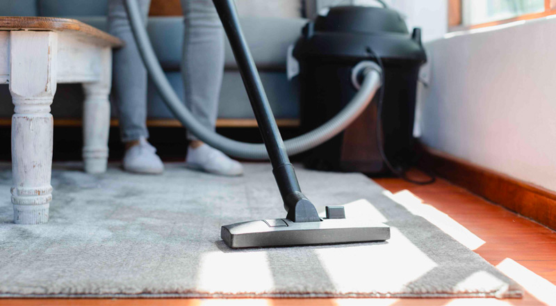 woman vacuuming viscose rug